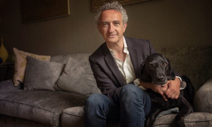 Author Simon Garfield with his dog Ludo, sitting on the couch together
